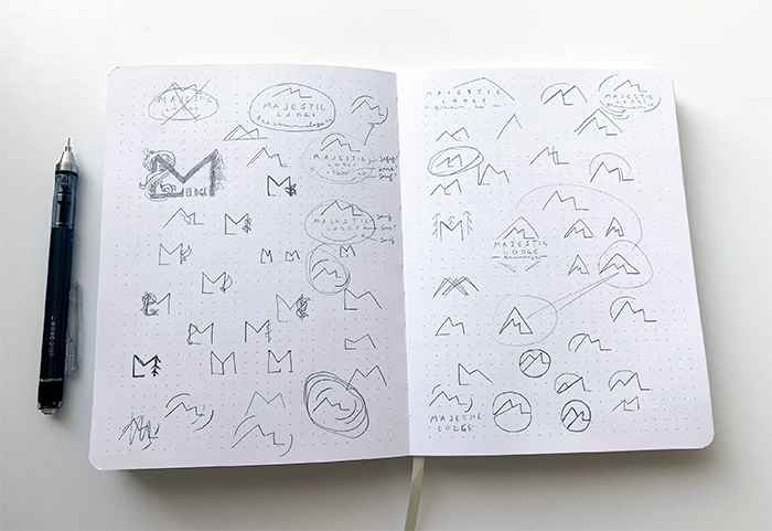 Two pages filled with logo sketches on paper